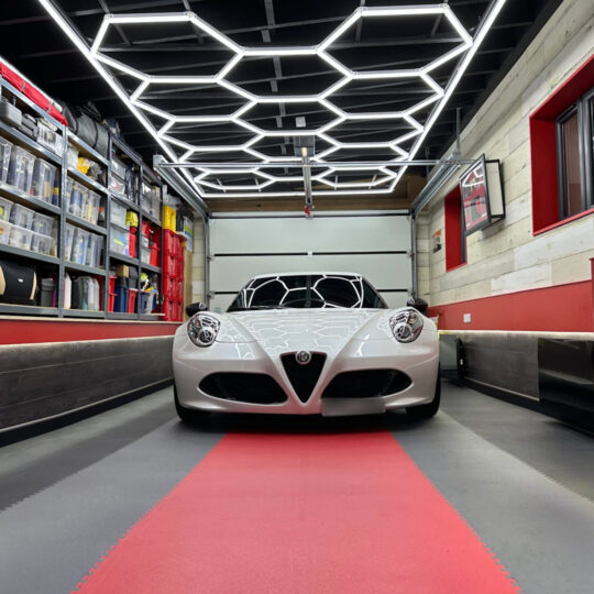 Duramat red and black floor mats in a car garage